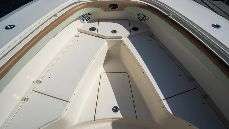 Slide: The Image of 2012 Scout 345 XSF boat interior with storage compartments and speakers. - 15