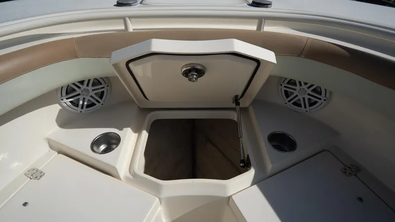 Slide: The Image of 2012 Scout 345 XSF boat interior with open storage compartment and speakers. - 17