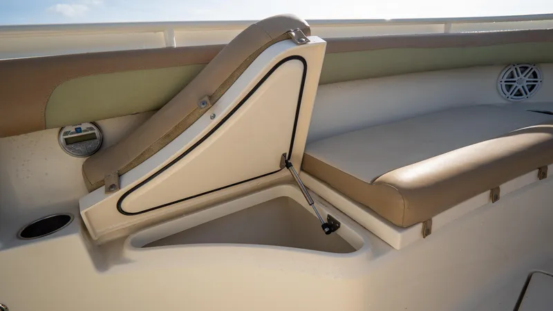 Slide: The Image of 2012 Scout 345 XSF boat seat with storage compartment open. - 19