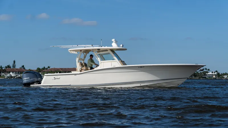Slide: The Image of 2012 Scout 345 XSF boat cruising on a sunny day. - 2