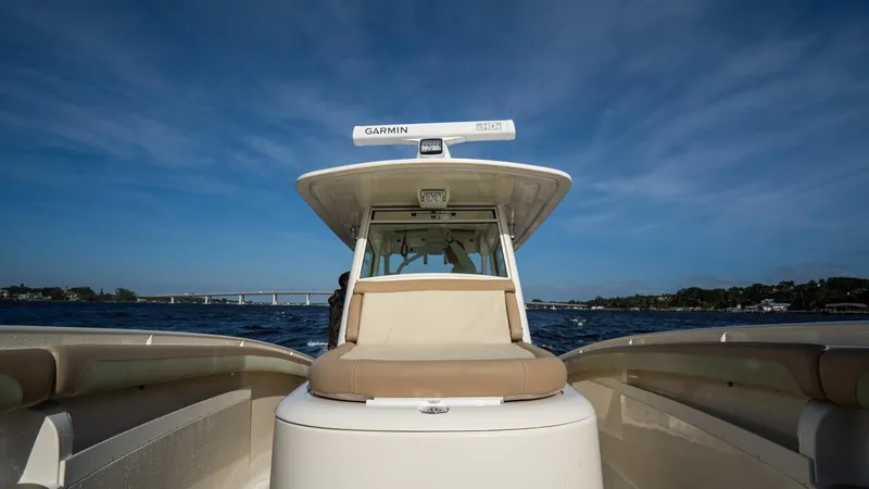 Slide: The Image of 2012 Scout 345 XSF boat on open water under clear blue sky. - 25