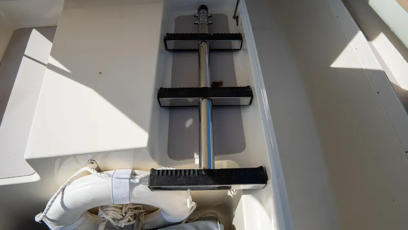 Slide: The Image of 2012 Scout 345 XSF boat interior with ladder and life jacket storage. - 27