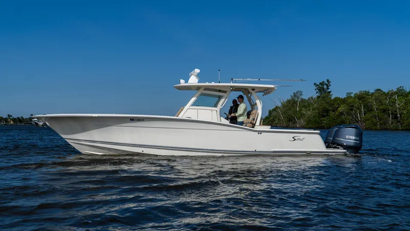 Slide: The Image of 2012 Scout 345 XSF boat cruising on a sunny day. - 29