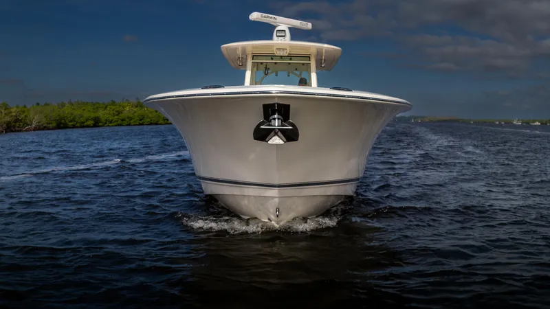 Slide: The Image of 2012 Scout 345 XSF boat cruising on open water under a clear sky. - 3