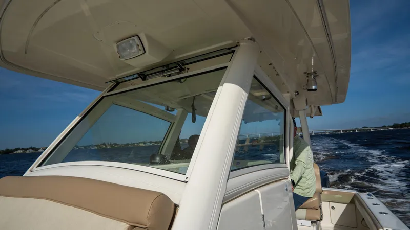 Slide: The Image of 2012 Scout 345 XSF boat cruising on open water under clear blue sky. - 33