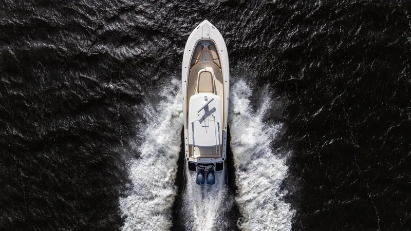 Slide: The Image of Aerial view of 2012 Scout 345 XSF boat cruising on water. - 34