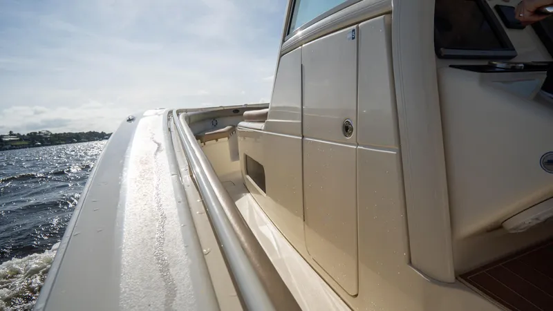 Slide: The Image of 2012 Scout 345 XSF boat cruising on water, side view. - 35