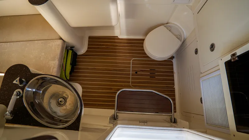 Slide: The Image of 2012 Scout 345 XSF boat interior with wooden flooring, sink, and toilet. - 36