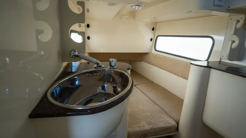 Slide: The Image of Interior of 2012 Scout 345 XSF boat with sink and seating area. - 38