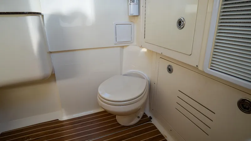 Slide: The Image of 2012 Scout 345 XSF boat bathroom with wooden flooring and compact design. - 39