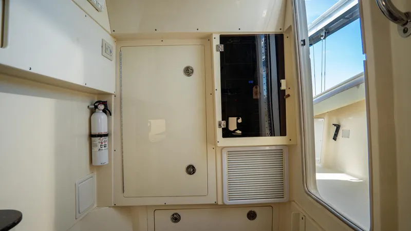 Slide: The Image of 2012 Scout 345 XSF interior with storage compartments and fire extinguisher. - 42