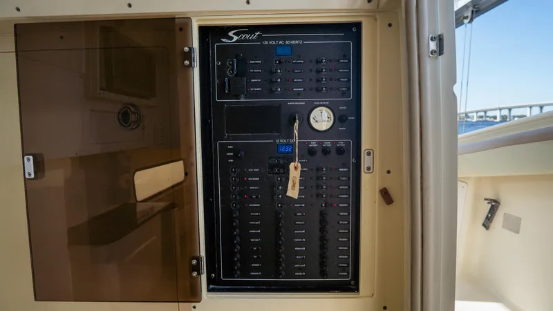 Slide: The Image of Electrical panel of 2012 Scout 345 XSF boat with open cover. - 43