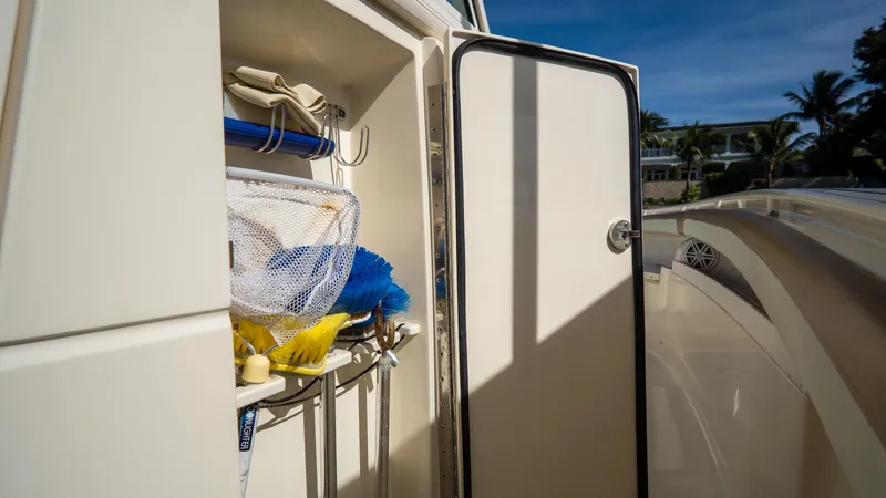 Slide: The Image of 2012 Scout 345 XSF boat storage compartment with fishing gear and accessories. - 45