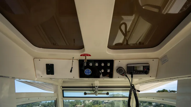 Slide: The Image of Interior view of 2012 Scout 345 XSF boat dashboard with controls and radio. - 48