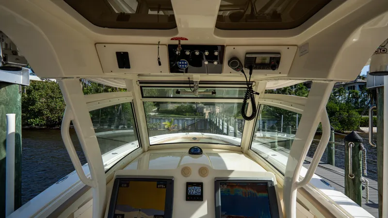 Slide: The Image of Interior view of 2012 Scout 345 XSF boat cockpit with navigation equipment. - 49