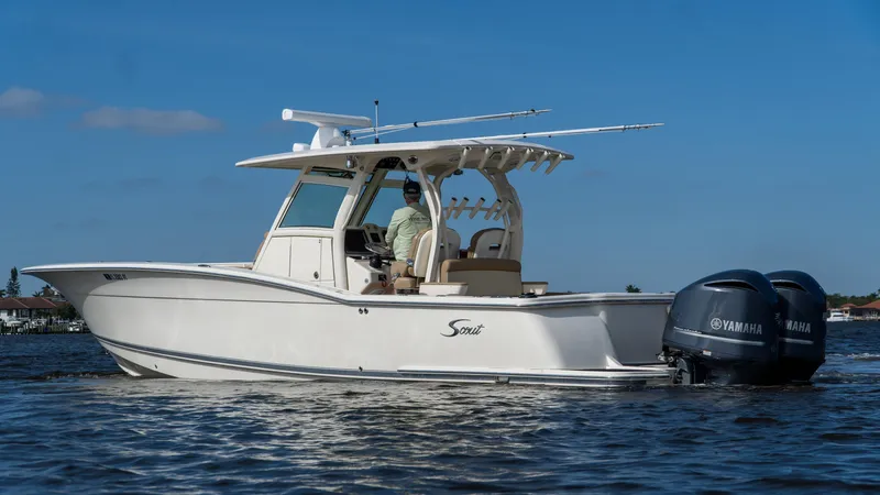 Slide: The Image of 2012 Scout 345 XSF boat with Yamaha engines on calm water. - 5