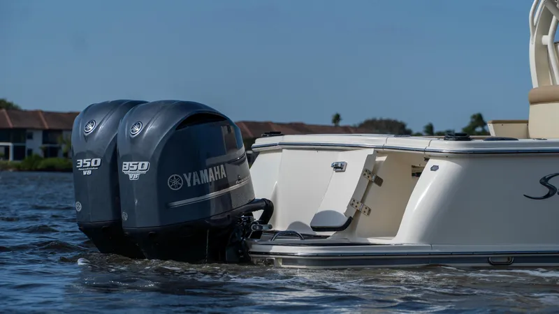 Slide: The Image of 2012 Scout 345 XSF boat with twin Yamaha 350 engines on water. - 9