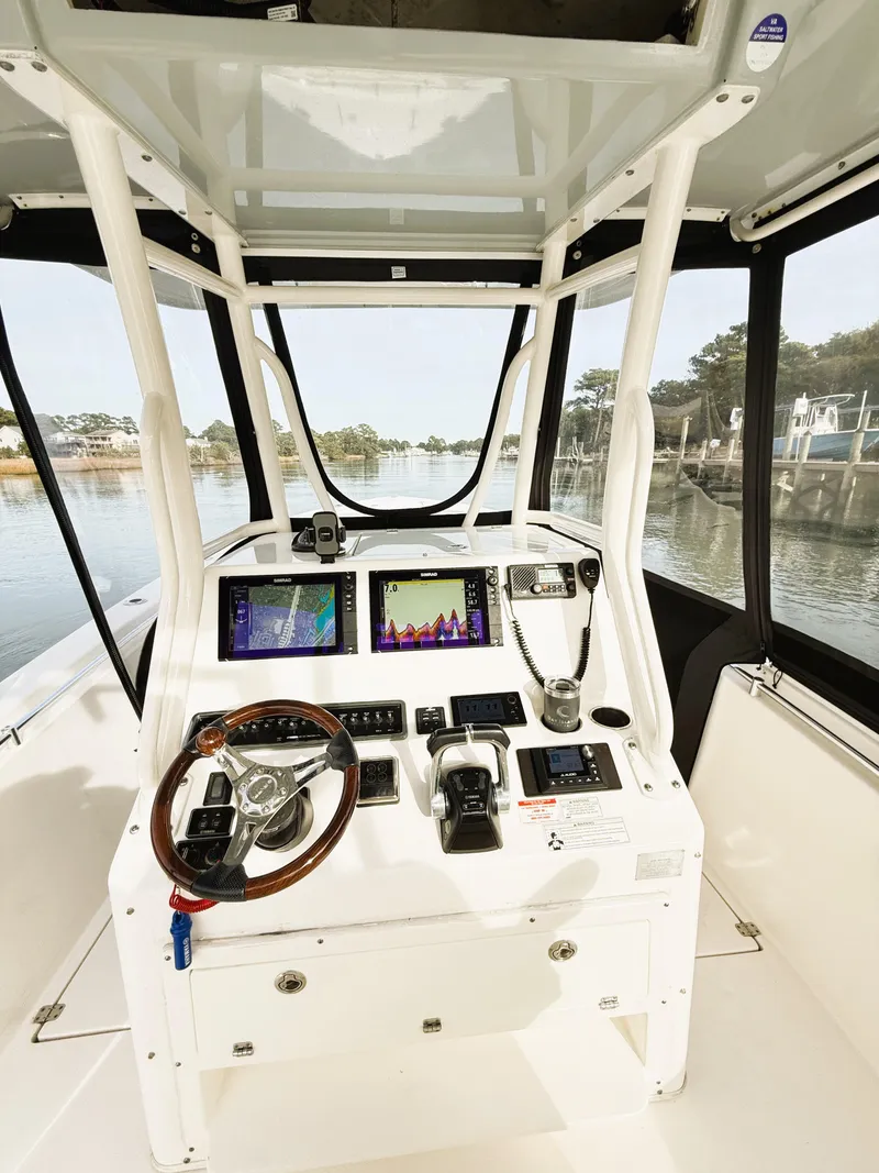 Slide: The Image of 2016 Cobia 296 Center Console boat interior with advanced navigation system. - 13