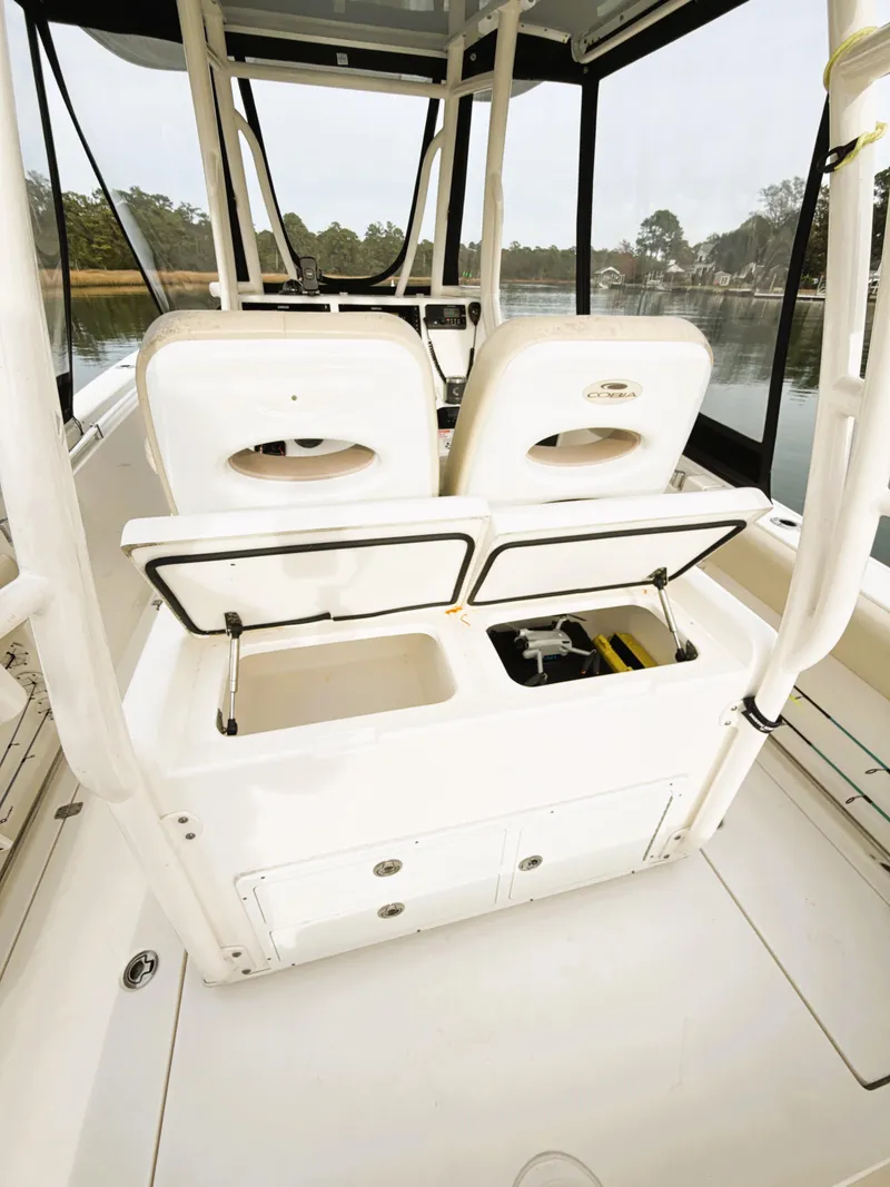 Slide: The Image of 2016 Cobia 296 Center Console boat interior with open storage compartments. - 17