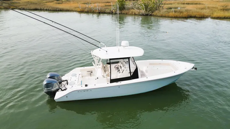 Slide: The Image of 2016 Cobia 296 Center Console boat on calm water. - 2