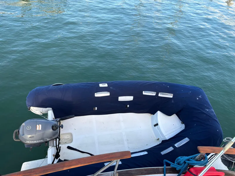 Slide: The Image of Inflatable boat with motor beside 1979 Ocean Yachts Trawler on calm water. - 10