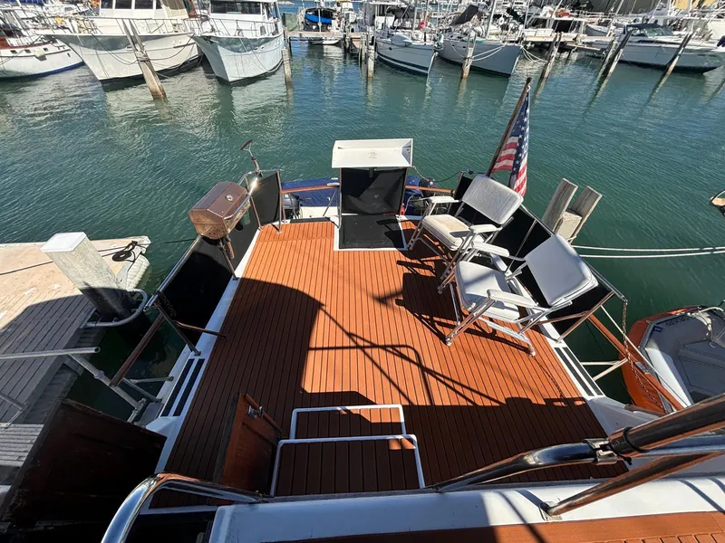 Slide: The Image of 1979 Ocean Yachts Trawler with wooden deck, docked at marina with surrounding boats. - 11