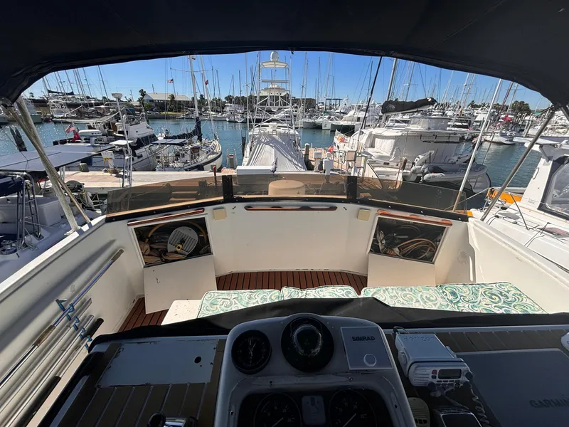 Slide: The Image of 1979 Ocean Yachts Trawler cockpit view in marina, surrounded by boats. - 19