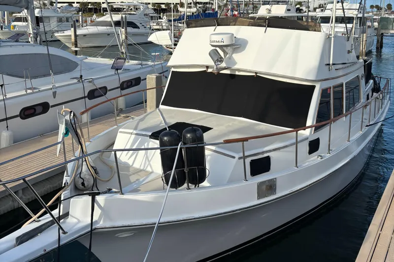 Slide: The Image of 1979 Ocean Yachts Trawler docked at marina, featuring classic design and spacious deck. - 2