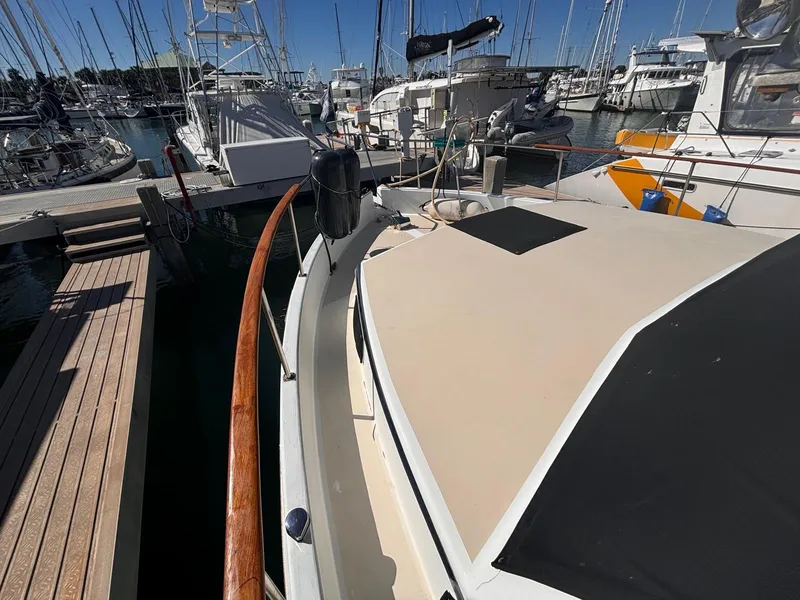 Slide: The Image of 1979 Ocean Yachts Trawler docked at marina, surrounded by other boats. - 22