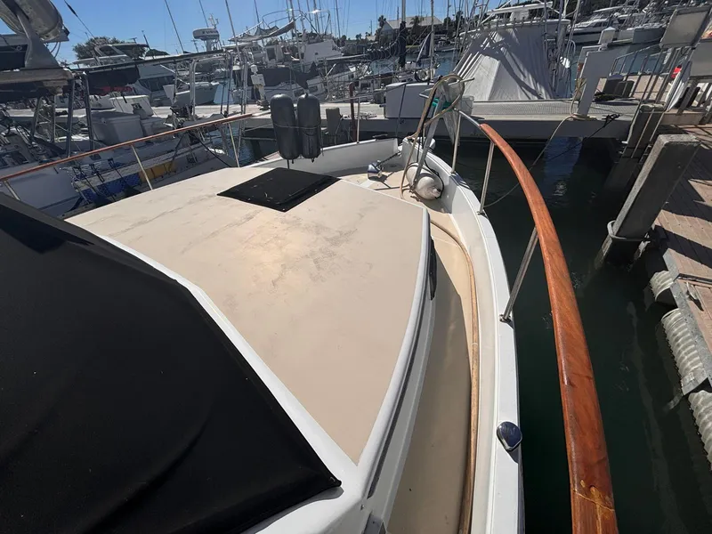 Slide: The Image of 1979 Ocean Yachts Trawler docked at marina, showcasing deck and railing. - 23
