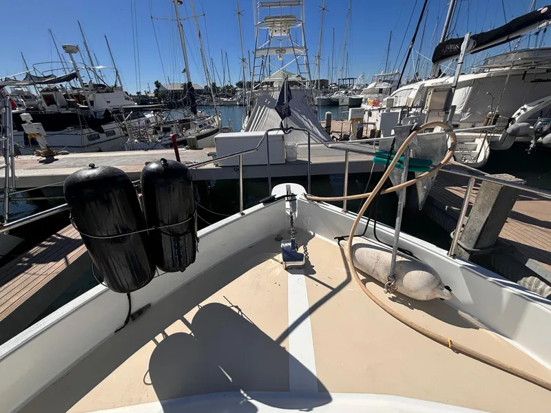 Slide: The Image of 1979 Ocean Yachts Trawler docked at marina with clear blue sky. - 25