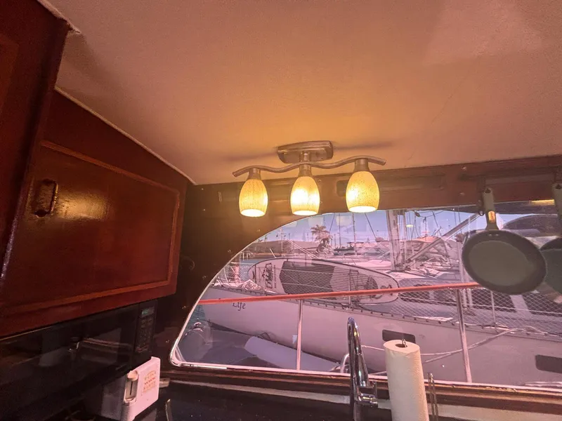Slide: The Image of Interior of 1979 Ocean Yachts Trawler with wooden cabinets and nautical view. - 29
