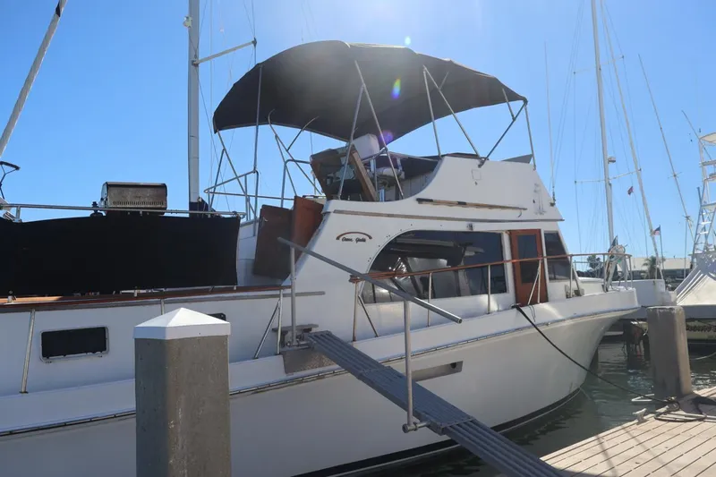 Slide: The Image of 1979 Ocean Yachts Trawler docked at marina under clear blue sky. - 3