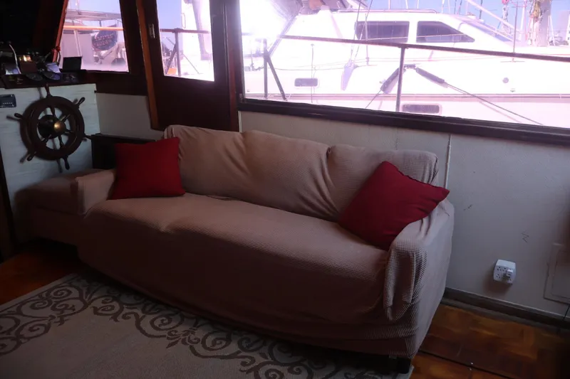 Slide: The Image of Cozy interior of 1979 Ocean Yachts Trawler with sofa and nautical decor. - 34