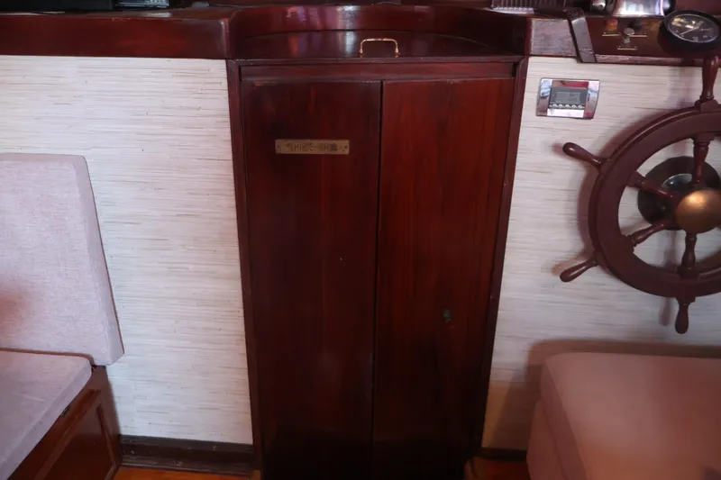 Slide: The Image of Interior of 1979 Ocean Yachts Trawler with wooden cabinet and ship's wheel. - 35