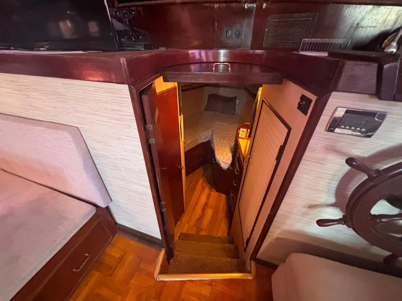 Slide: The Image of Interior of a 1979 Ocean Yachts Trawler, featuring cozy cabin and wooden accents. - 36