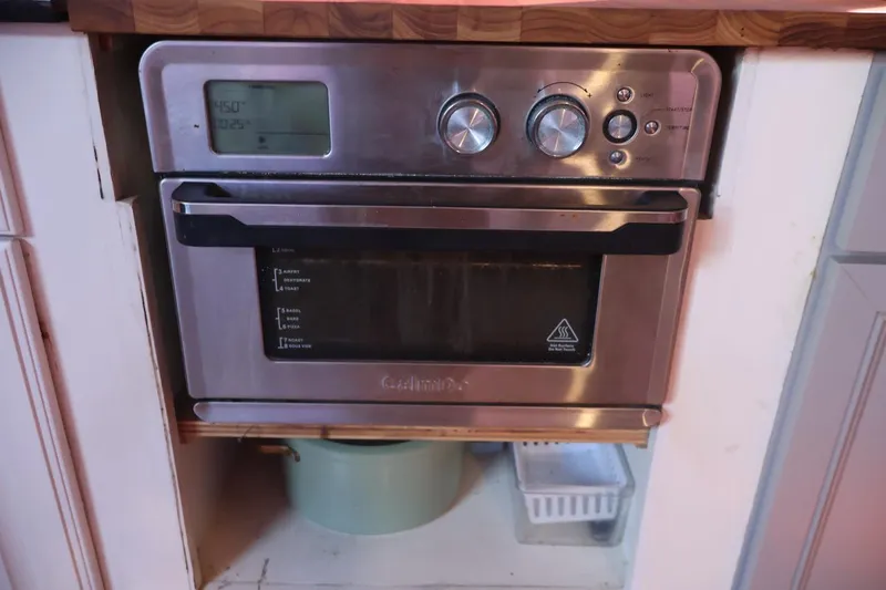 Slide: The Image of Stainless steel oven in a kitchen setting on a 1979 Ocean Yachts Trawler. - 39