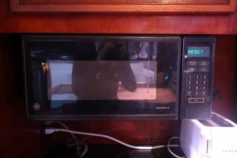 Slide: The Image of Microwave inside 1979 Ocean Yachts Trawler, with digital display and keypad. - 41