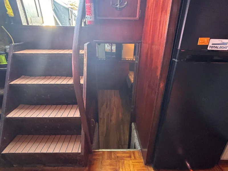 Slide: The Image of Interior of 1979 Ocean Yachts Trawler with wooden stairs and refrigerator. - 42