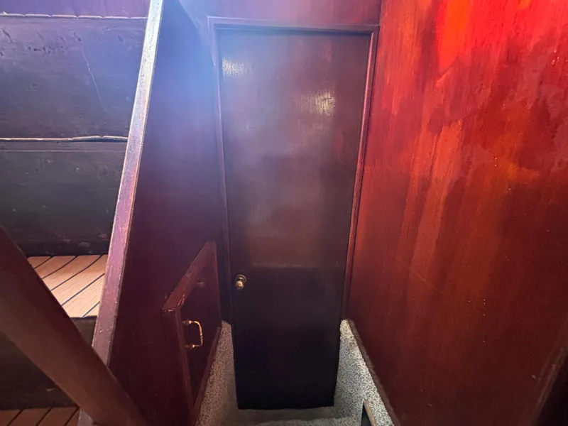 Slide: The Image of Interior of 1979 Ocean Yachts Trawler with wooden door and stairs. - 43