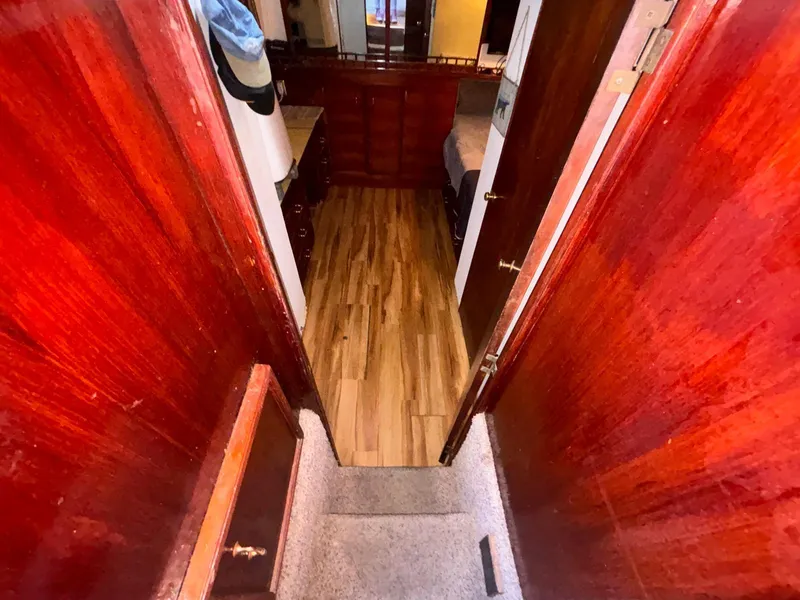 Slide: The Image of 1979 Ocean Yachts Trawler interior with wooden flooring and rich wood paneling. - 44