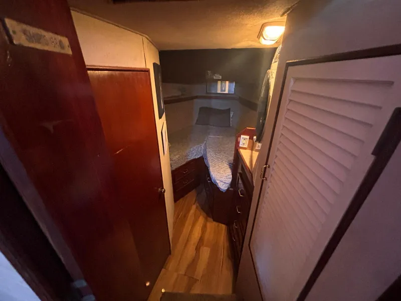 Slide: The Image of Cozy cabin interior of 1979 Ocean Yachts Trawler with wood accents and soft lighting. - 45