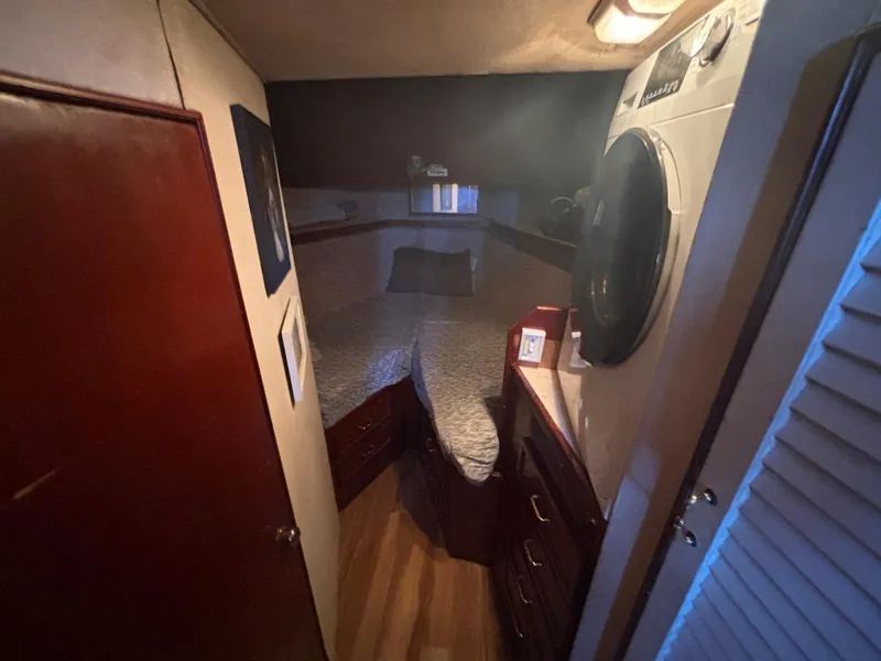 Slide: The Image of 1979 Ocean Yachts Trawler cabin interior with bed, storage, and porthole. - 46