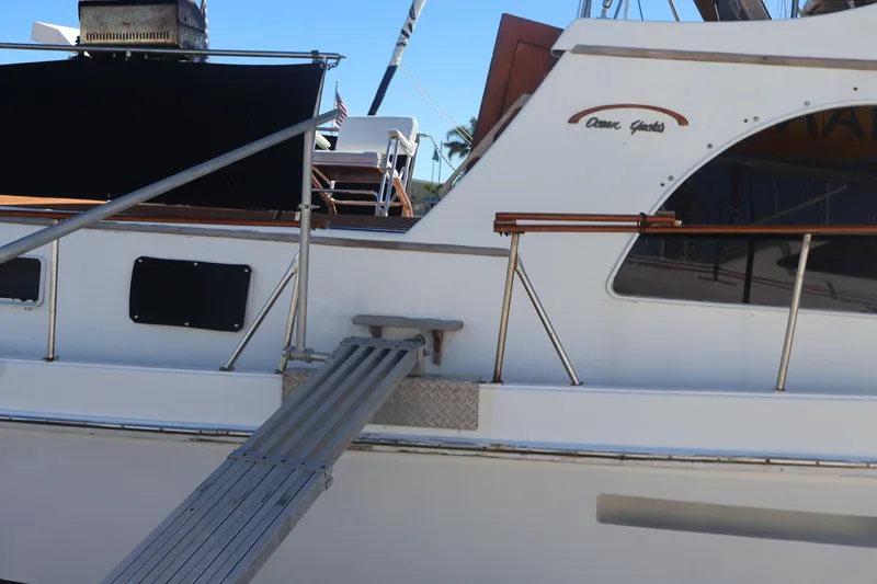 Slide: The Image of 1979 Ocean Yachts Trawler with gangway, white exterior, docked. - 5