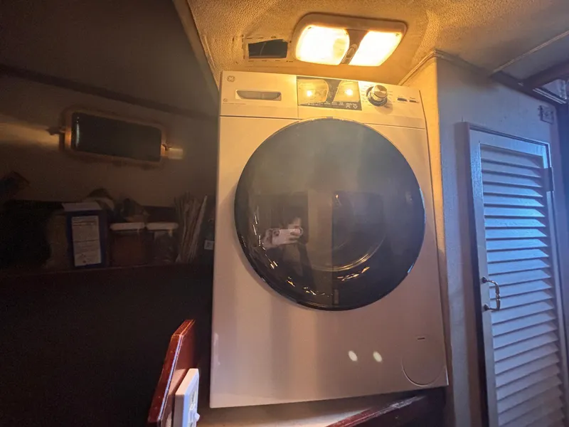 Slide: The Image of Washing machine inside 1979 Ocean Yachts Trawler, illuminated by overhead light. - 50