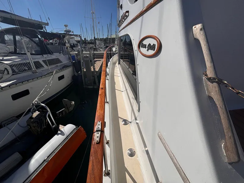 Slide: The Image of 1979 Ocean Yachts Trawler docked at marina, side view with wooden railings. - 6