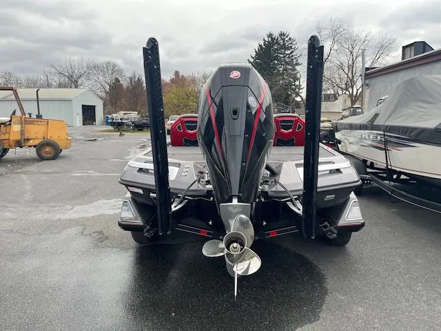Slide: The Image of 2025 Ranger Z519R boat with powerful outboard motor, parked outdoors on a cloudy day. - 5