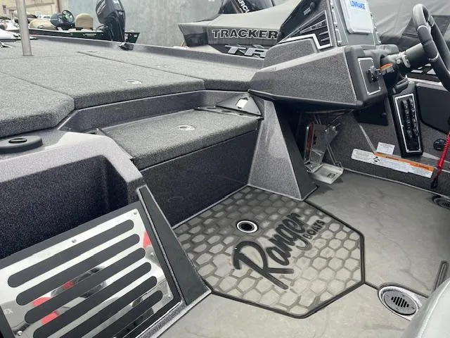 Slide: The Image of 2025 Ranger Z519R boat interior with steering console and storage compartments. - 6