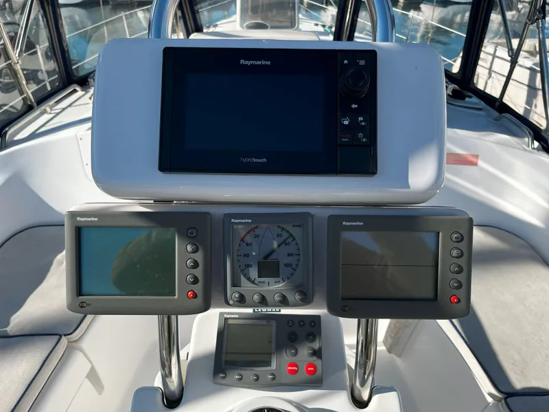 Slide: The Image of 2005 Hunter 41 yacht cockpit with navigation instruments and Raymarine displays. - 14