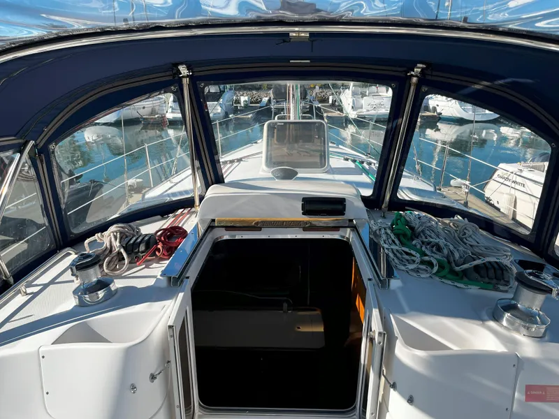 Slide: The Image of Interior view of 2005 Hunter 41 sailboat cockpit with ropes and marina background. - 17